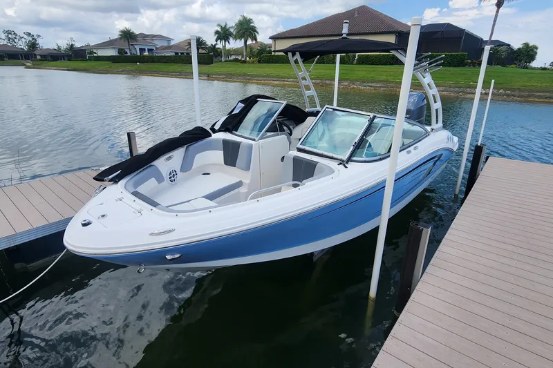 Slide: The Image of 2022 Chaparral 21 SSi OB boat docked on a serene lake. - 53