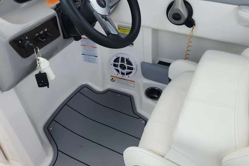 Slide: The Image of Interior of 2022 Chaparral 21 SSi OB boat showing steering wheel and seating area. - 60