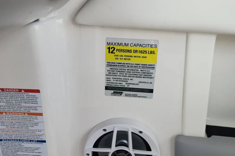 Slide: The Image of 2022 Chaparral 21 SSi OB capacity label, maximum 12 persons or 1625 lbs, safety warnings. - 61