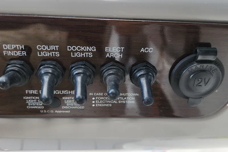 Slide: The Image of Control panel of 2022 Chaparral 21 SSi OB boat with switches and 12V outlet. - 63