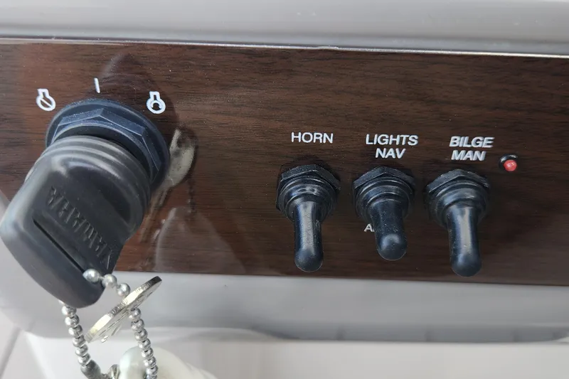Slide: The Image of 2022 Chaparral 21 SSi OB dashboard with ignition key and control switches. - 65