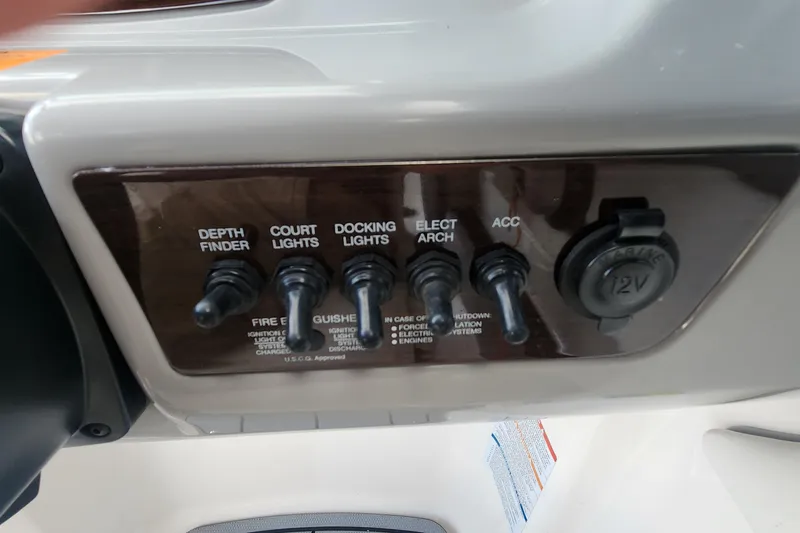 Slide: The Image of Control panel of 2022 Chaparral 21 SSi OB boat with switches and 12V outlet. - 70