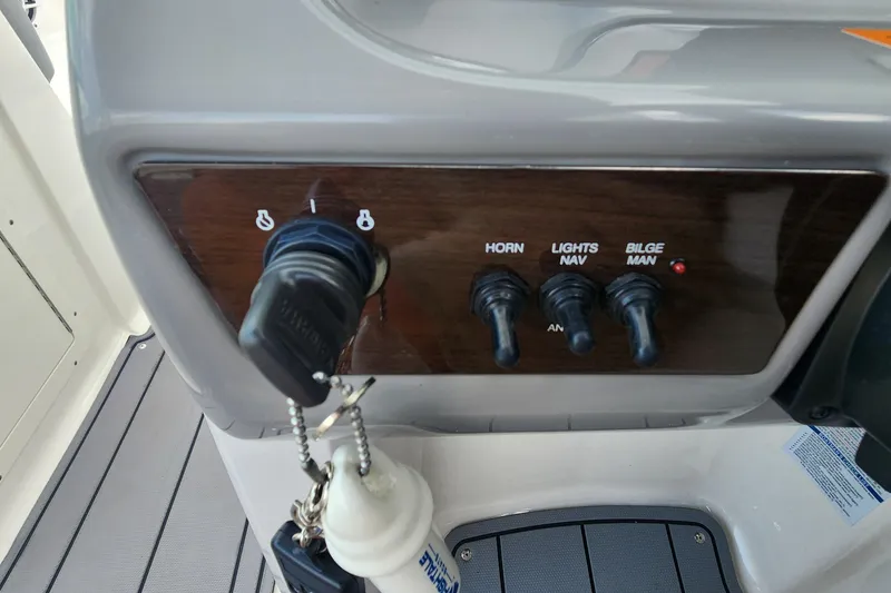 Slide: The Image of Control panel of 2022 Chaparral 21 SSi OB boat with ignition and switches. - 72