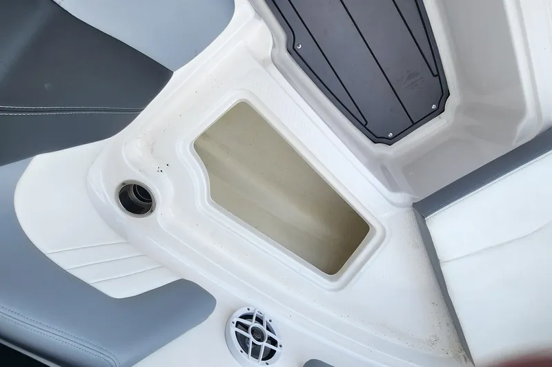 Slide: The Image of Interior view of a 2022 Chaparral 21 SSi OB boat, featuring seating and storage compartments. - 74