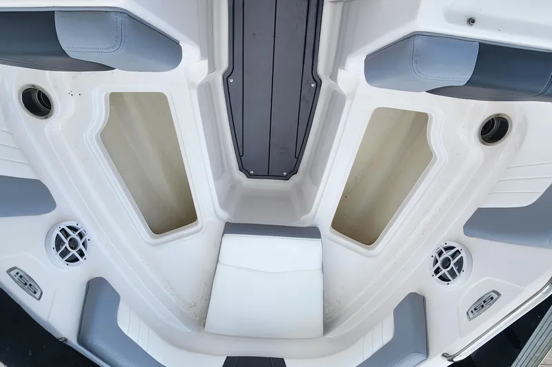 Slide: The Image of 2022 Chaparral 21 SSi OB boat interior with seating and storage compartments. - 75