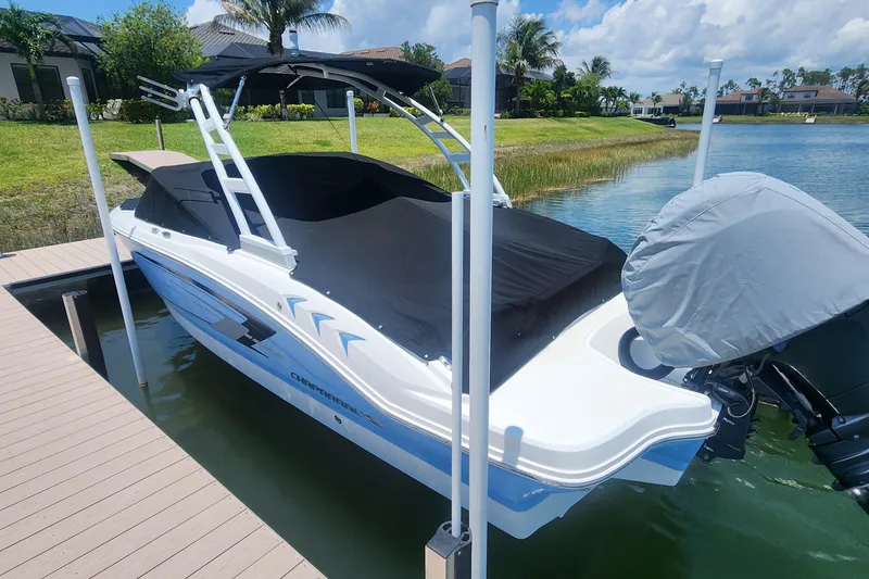 Slide: The Image of 2022 Chaparral 21 SSi OB boat docked on a sunny day, covered and ready for use. - 9