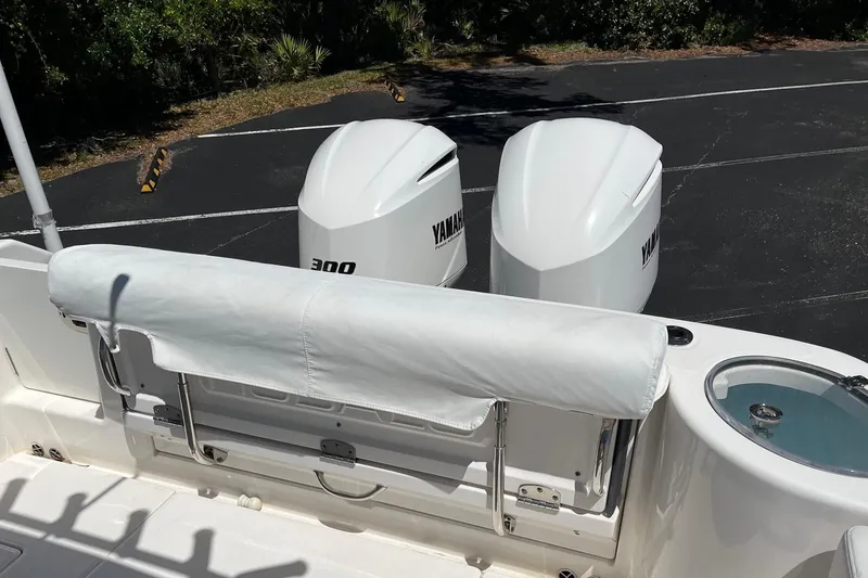 Slide: The Image of 2019 Robalo R302 Center Console with twin Yamaha 300 engines, rear seating, and livewell. - 13