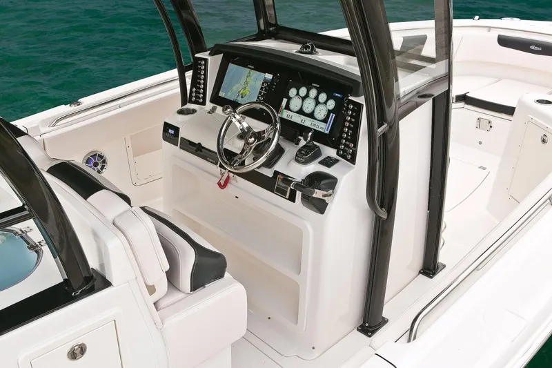 Slide: The Image of Manufacturer Provided Image: 2019 Robalo R302 Center Console boat helm with navigation system and steering wheel. - 4