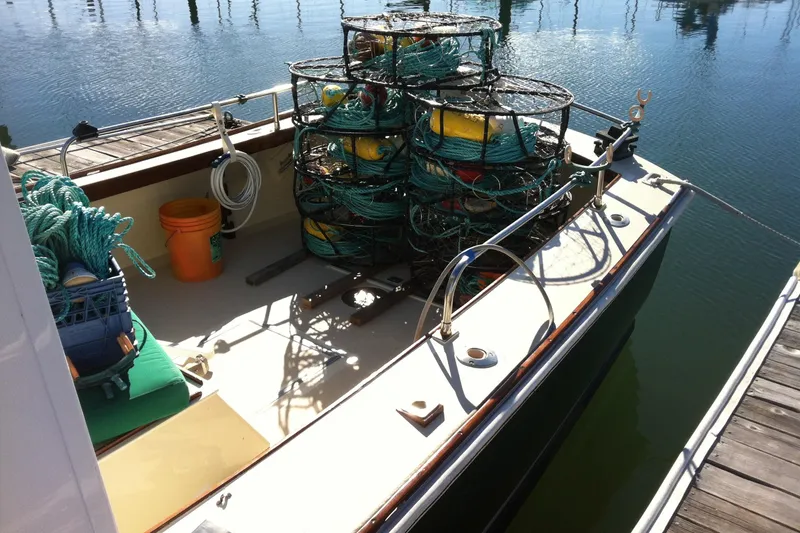 Slide: The Image of 1974 Dyer 29' Sport Fisher boat with fishing gear and traps on deck. - 13