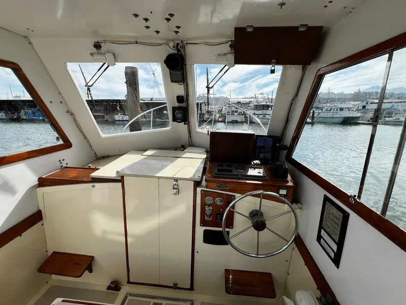 Slide: The Image of Interior view of a 1974 Dyer 29' Sport Fisher boat with steering wheel and control panel. - 20