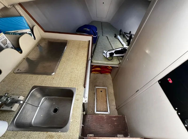 Slide: The Image of 1974 Dyer 29' Sport Fisher interior with sink, counter, and sleeping area. - 27