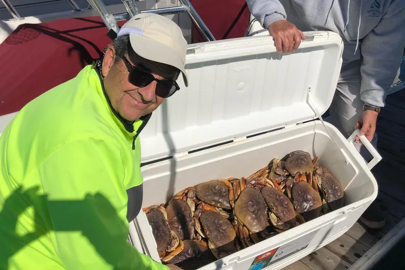 Slide: The Image of Man with cooler full of crabs on a 1974 Dyer 29' Sport fisher boat. - 35