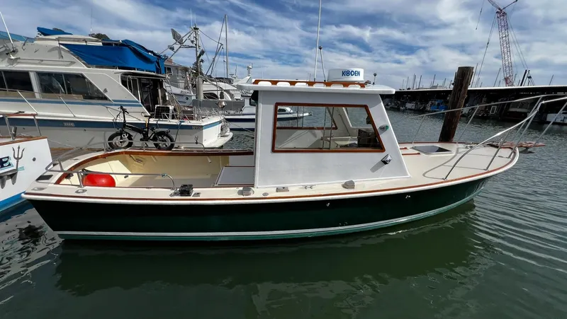 Slide: The Image of 1974 Dyer 29' Sport Fisher boat docked in marina, clear sky background. - 7