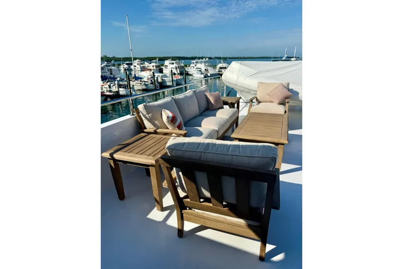 Slide: The Image of Luxurious outdoor seating on 2001 Hargrave 94 yacht, overlooking marina with boats. - 10