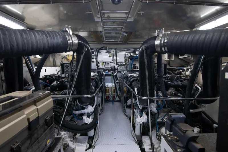 Slide: The Image of Engine room of a 2001 Hargrave 94 yacht, showcasing complex machinery and piping. - 100