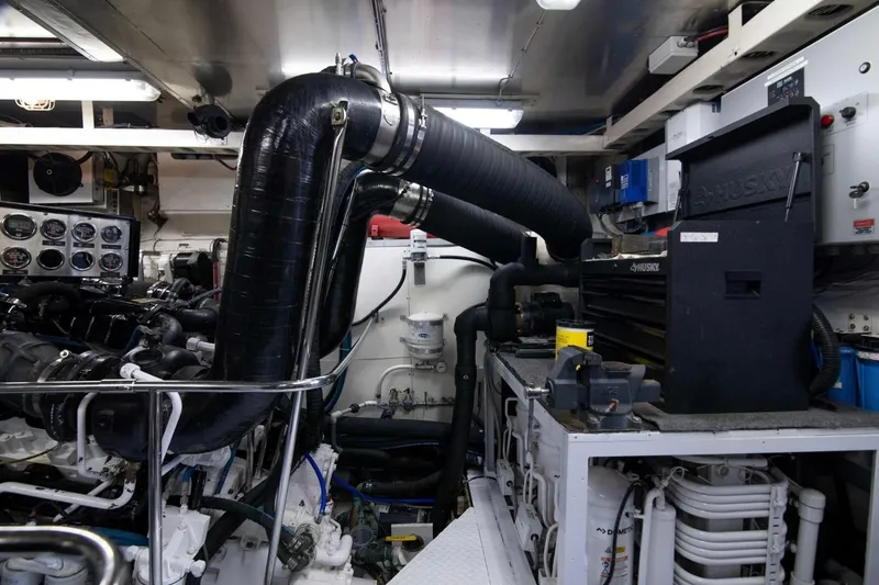 Slide: The Image of Engine room of a 2001 Hargrave 94 yacht, featuring complex machinery and control panels. - 101