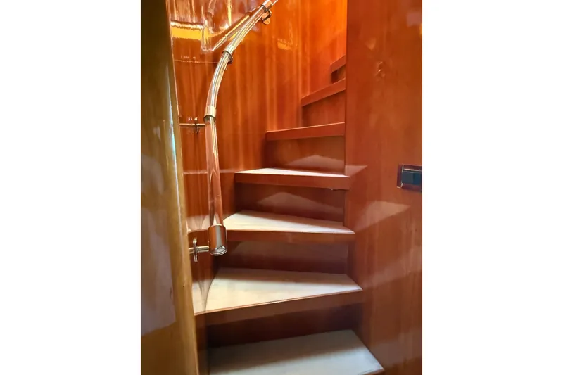 Slide: The Image of Wooden staircase with sleek railing inside a 2001 Hargrave 94 yacht. - 17