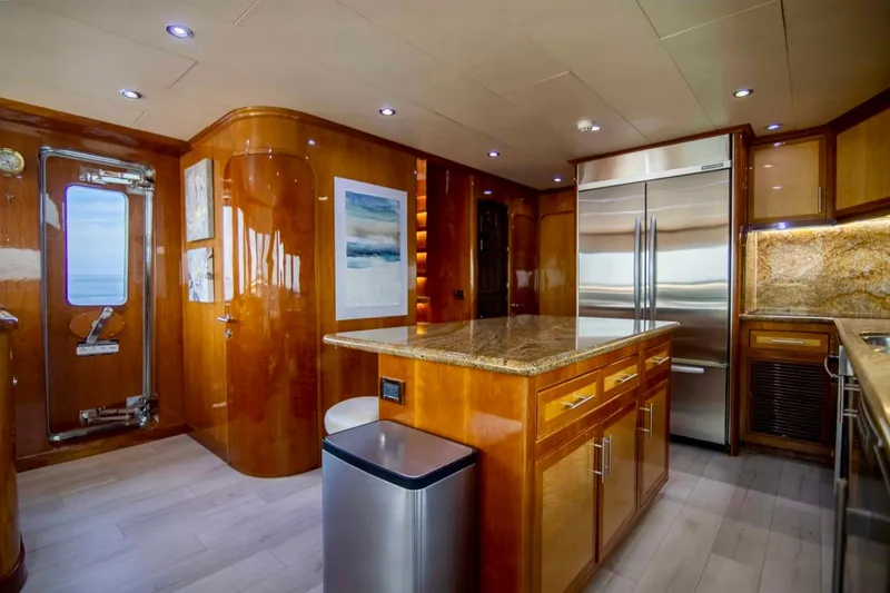 Slide: The Image of Luxurious kitchen interior of 2001 Hargrave 94 yacht with wood finishes and modern appliances. - 19