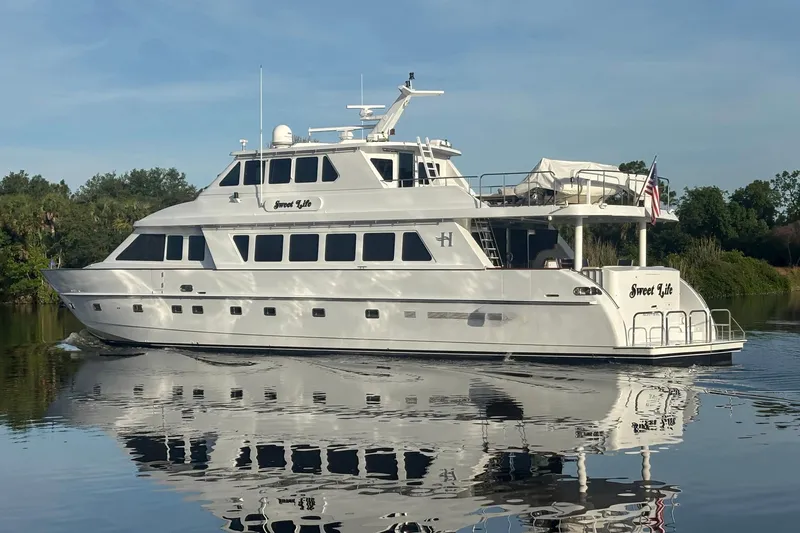 Slide: The Image of Luxury 2001 Hargrave 94 yacht cruising on calm waters, reflecting serene surroundings. - 2