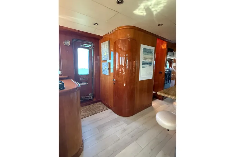 Slide: The Image of Luxurious interior of a 2001 Hargrave 94 yacht with elegant wood paneling and modern decor. - 20