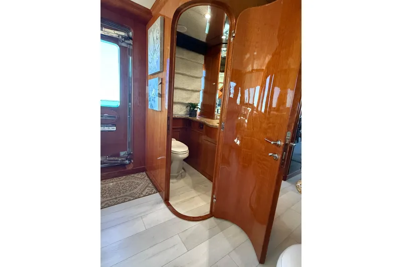 Slide: The Image of Luxurious wooden bathroom interior on a 2001 Hargrave 94 yacht, featuring elegant fixtures. - 22