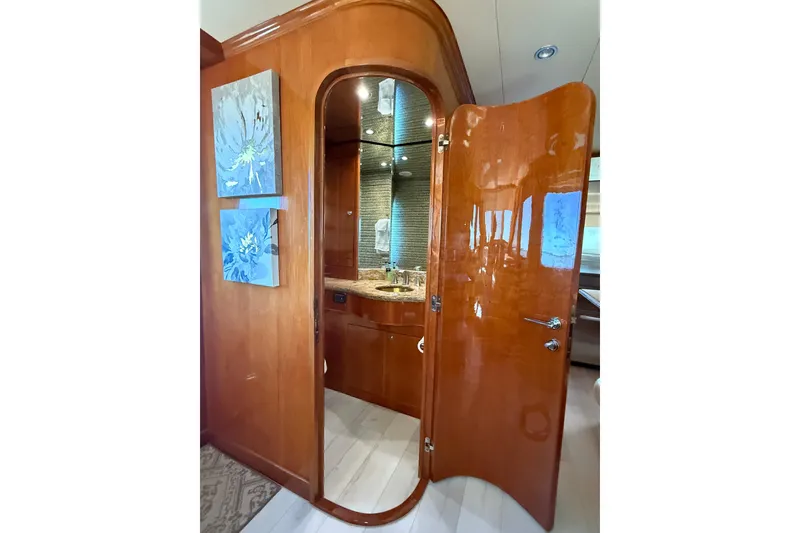 Slide: The Image of Luxurious wooden interior of 2001 Hargrave 94 yacht, featuring elegant bathroom entrance. - 23
