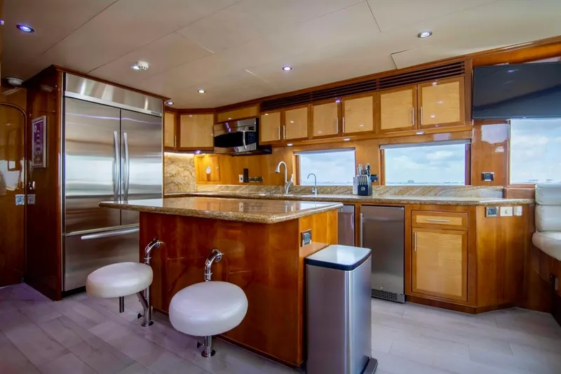 Slide: The Image of Luxurious yacht kitchen interior with wooden cabinetry, stainless steel appliances, and granite countertops, Hargrave 94. - 25