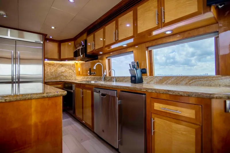 Slide: The Image of Luxurious kitchen interior on a 2001 Hargrave 94 yacht, featuring modern appliances and wood cabinetry. - 29