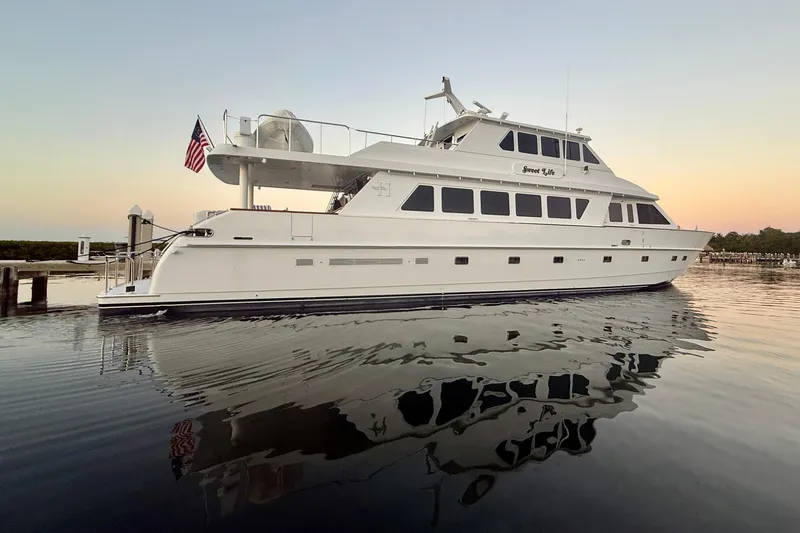 Slide: The Image of Luxury 2001 Hargrave 94 yacht docked at sunset, reflecting on calm water. - 3