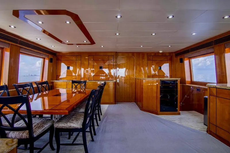 Slide: The Image of Luxurious interior of 2001 Hargrave 94 yacht with elegant dining area and panoramic windows. - 32