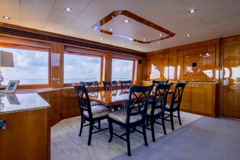 Slide: The Image of Luxurious dining area on a 2001 Hargrave 94 yacht with elegant wood finishes and ocean views. - 33