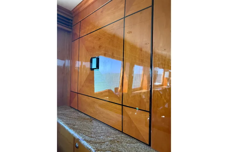Slide: The Image of Luxurious wood-paneled interior of a 2001 Hargrave 94 yacht with granite countertop. - 34