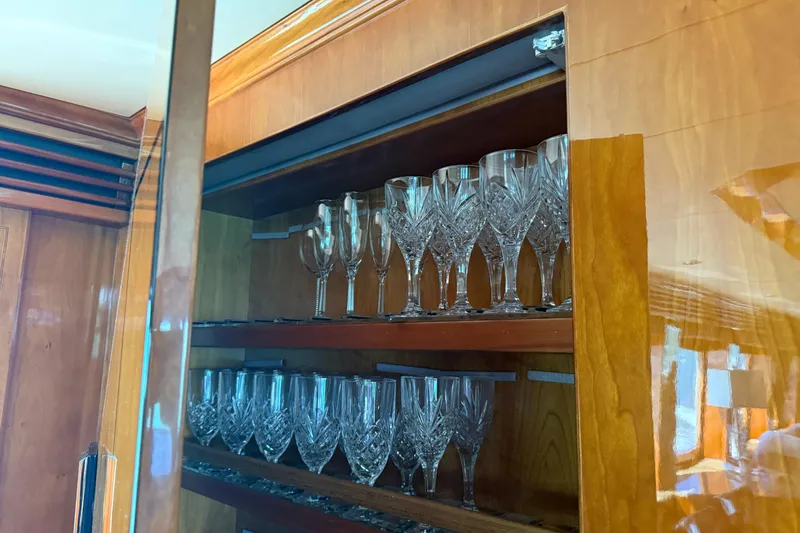 Slide: The Image of Luxury glassware cabinet on a 2001 Hargrave 94 yacht, featuring elegant crystal glasses. - 35