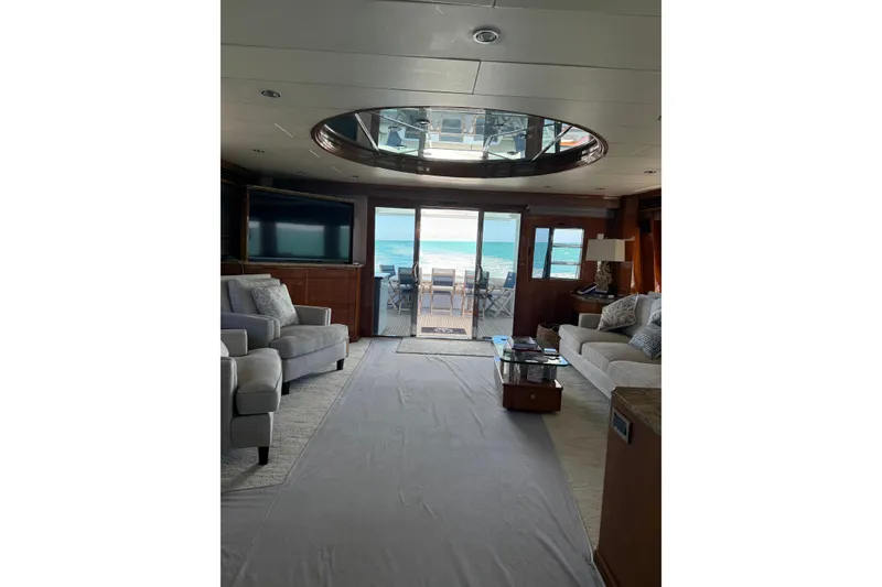 Slide: The Image of Luxurious interior of 2001 Hargrave 94 yacht with ocean view through glass doors. - 38