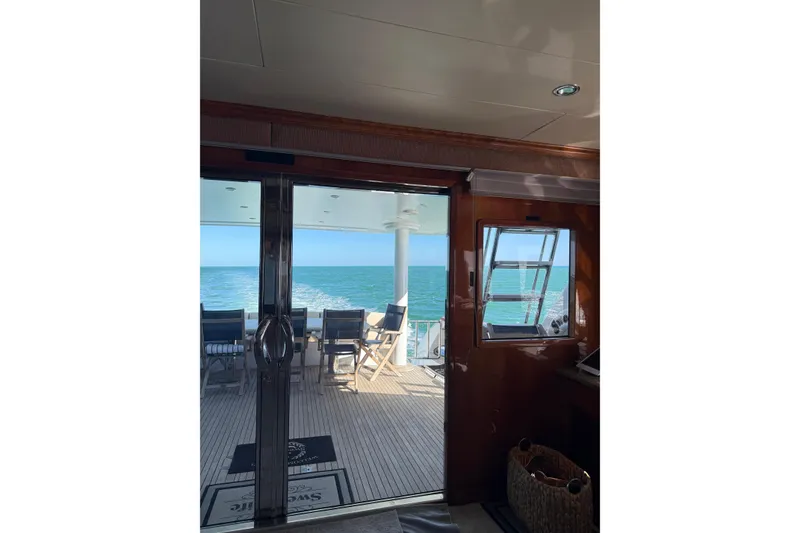 Slide: The Image of Interior view of 2001 Hargrave 94 yacht, overlooking ocean through glass doors. - 46