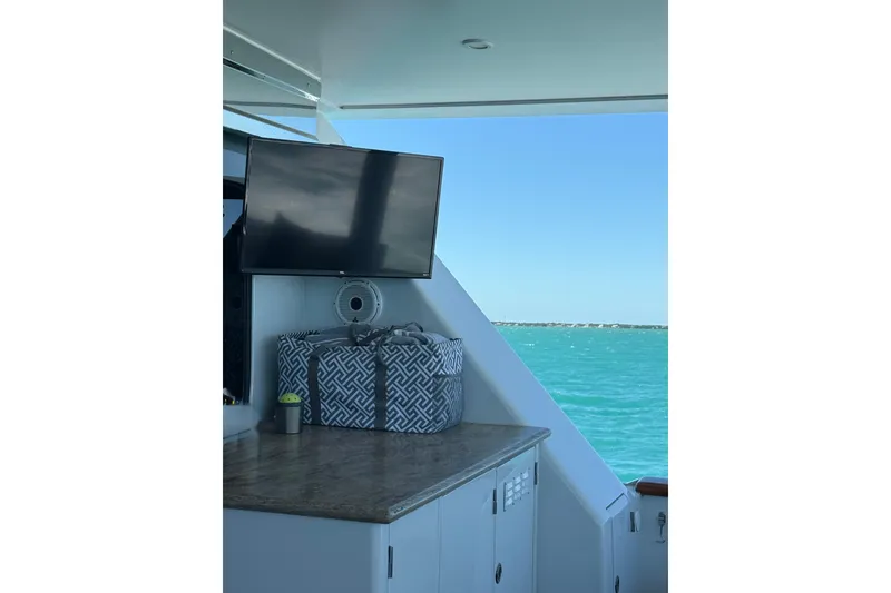 Slide: The Image of Luxurious Hargrave 94 yacht interior with TV, storage, and ocean view, 2001 model. - 48