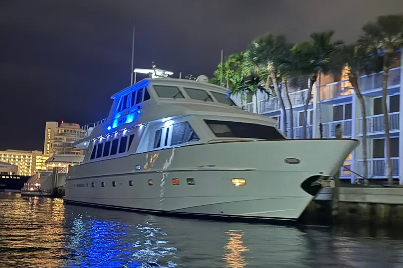 Slide: The Image of Luxurious 2001 Hargrave 94 yacht docked at night, illuminated by blue lights. - 5