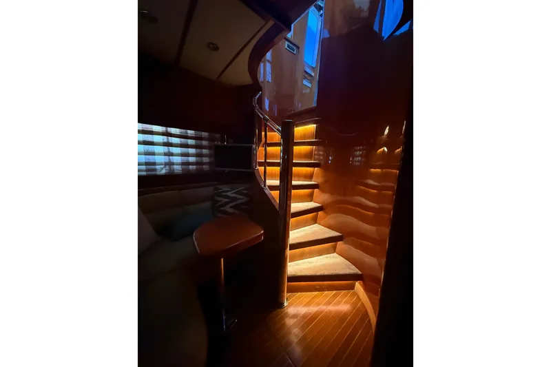 Slide: The Image of Luxurious interior of 2001 Hargrave 94 yacht with elegant wooden staircase and ambient lighting. - 50