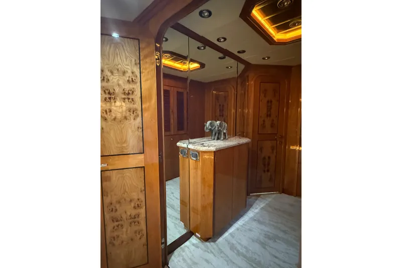 Slide: The Image of Luxurious wooden interior of a 2001 Hargrave 94 yacht with elegant decor and lighting. - 55
