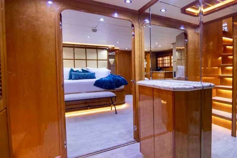 Slide: The Image of Luxurious interior of 2001 Hargrave 94 yacht with elegant wood finishes and plush bedding. - 56