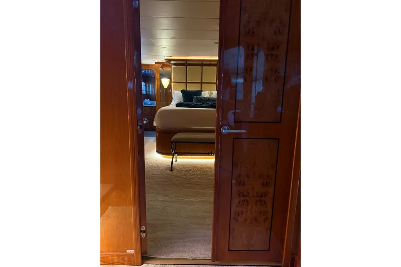 Slide: The Image of Luxurious bedroom interior on a 2001 Hargrave 94 yacht, featuring elegant wood finishes. - 57