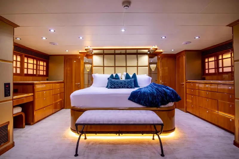 Slide: The Image of Luxurious master bedroom on 2001 Hargrave 94 yacht, featuring elegant wood finishes and ambient lighting. - 62
