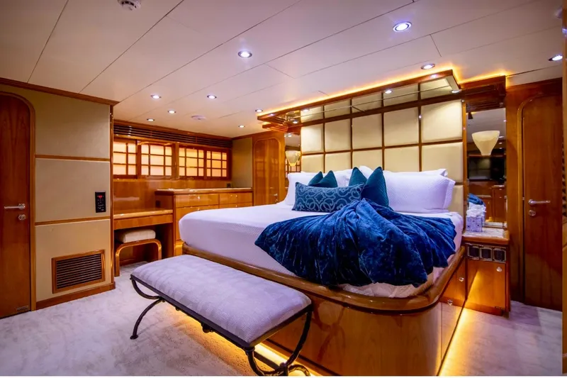 Slide: The Image of Luxurious bedroom interior on a 2001 Hargrave 94 yacht, featuring elegant wood finishes and plush bedding. - 63