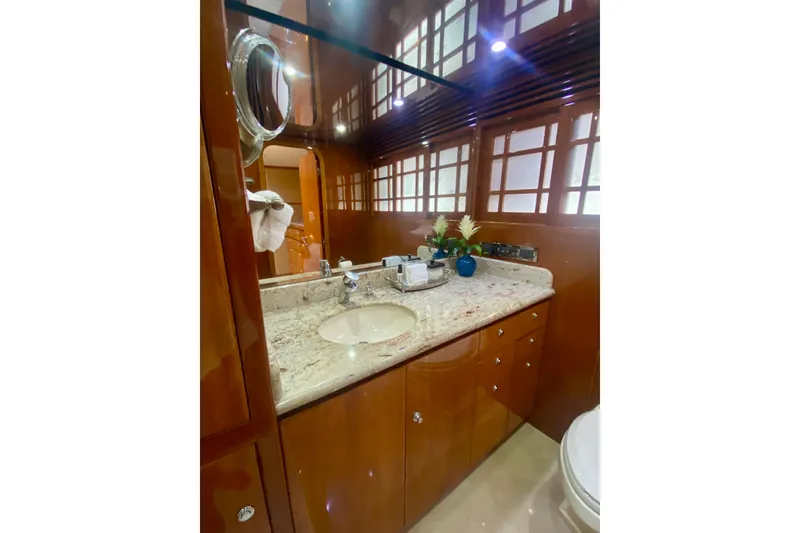Slide: The Image of Luxurious bathroom in 2001 Hargrave 94 yacht with elegant wood cabinetry and marble countertop. - 66