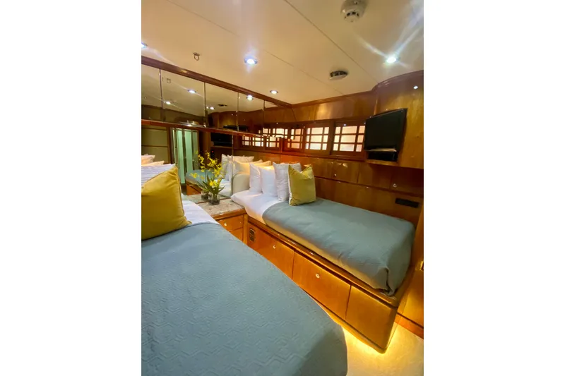 Slide: The Image of Luxurious cabin interior of 2001 Hargrave 94 yacht with cozy bedding and elegant wood finishes. - 72