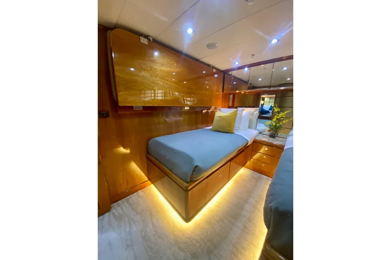 Slide: The Image of Luxurious cabin interior of 2001 Hargrave 94 yacht with elegant wood finish and ambient lighting. - 73