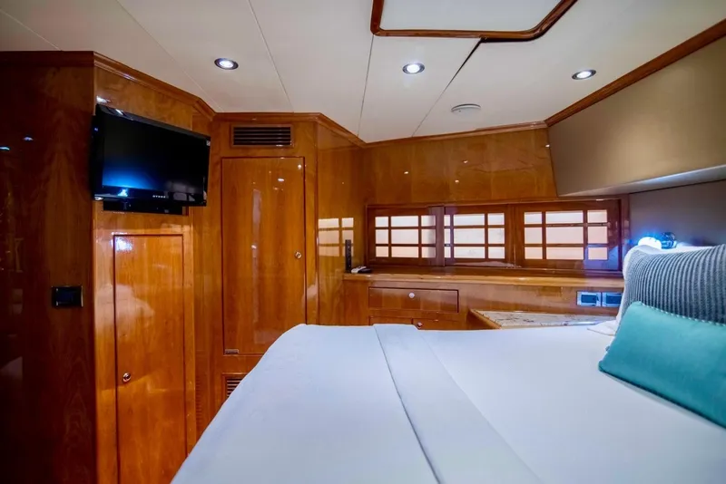 Slide: The Image of Luxurious cabin interior of a 2001 Hargrave 94 yacht with wood paneling and modern amenities. - 76