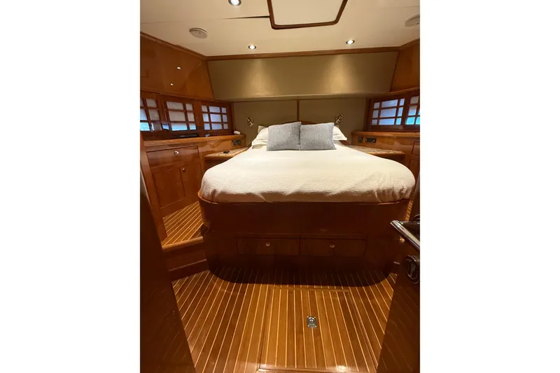 Slide: The Image of Luxurious cabin interior of 2001 Hargrave 94 yacht with wooden finishes and cozy bedding. - 78
