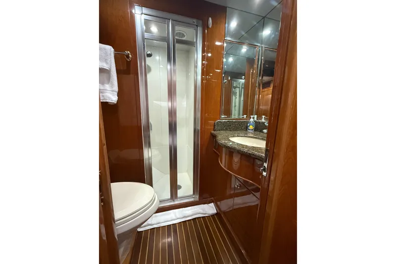 Slide: The Image of Luxurious bathroom in 2001 Hargrave 94 yacht with wood accents and modern fixtures. - 80