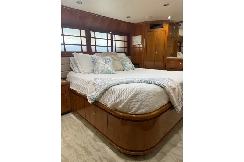 Slide: The Image of Luxurious bedroom interior on a 2001 Hargrave 94 yacht, featuring elegant wood finishes. - 81